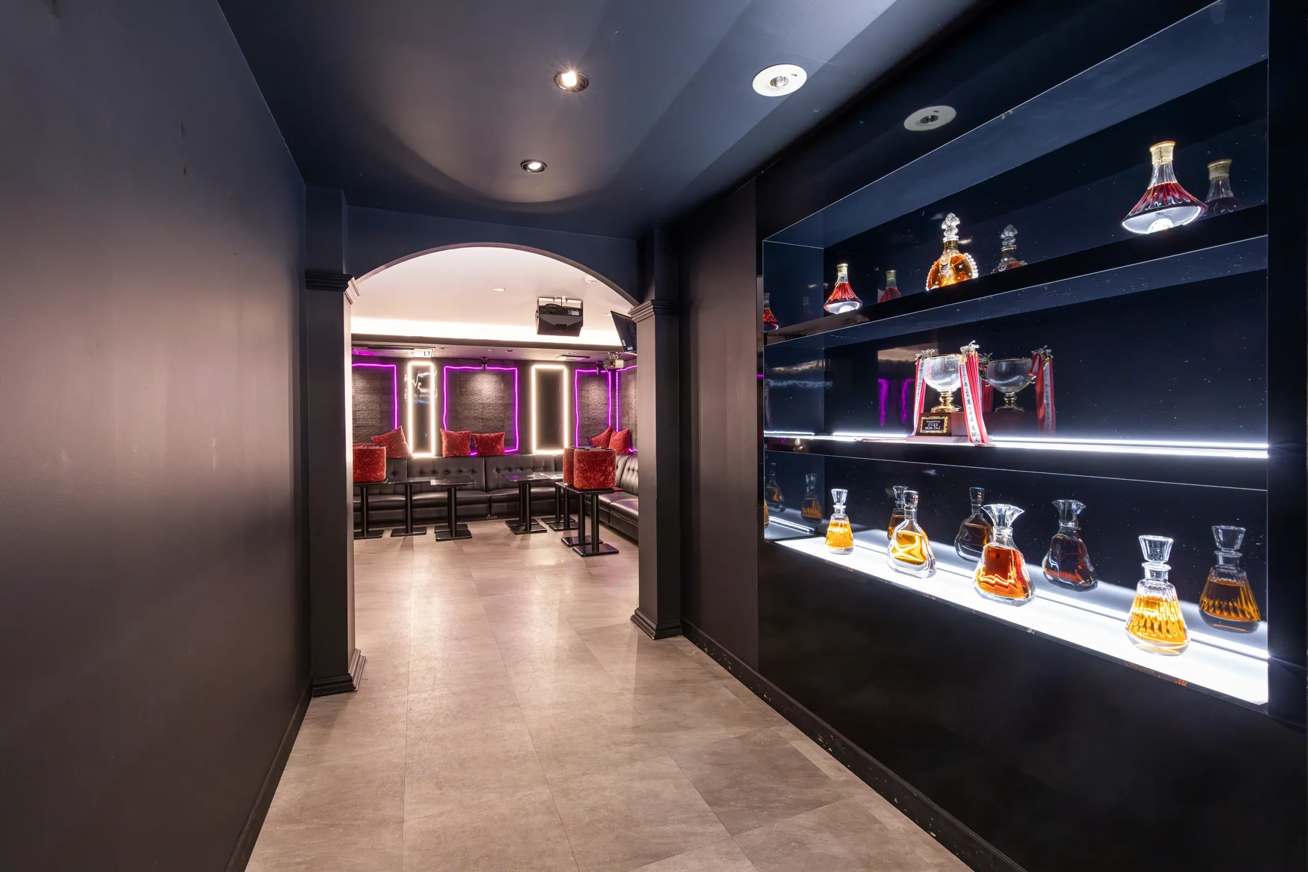 Elegant hallway inside a host bar in Japan displaying premium bottles and lounge entrance