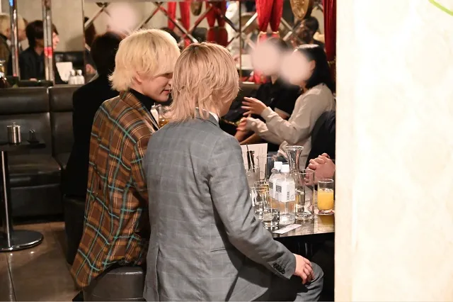 Hosts talking with guests inside a Japanese host club in Tokyo