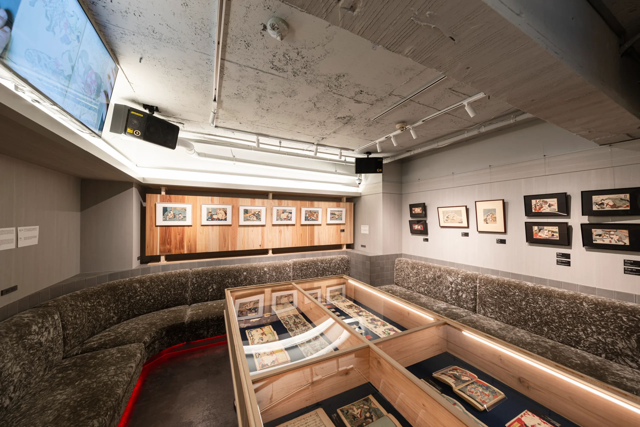 Interior of a Shunga art exhibition in Tokyo featuring framed Edo-period Japanese woodblock prints displayed in a curated museum space.